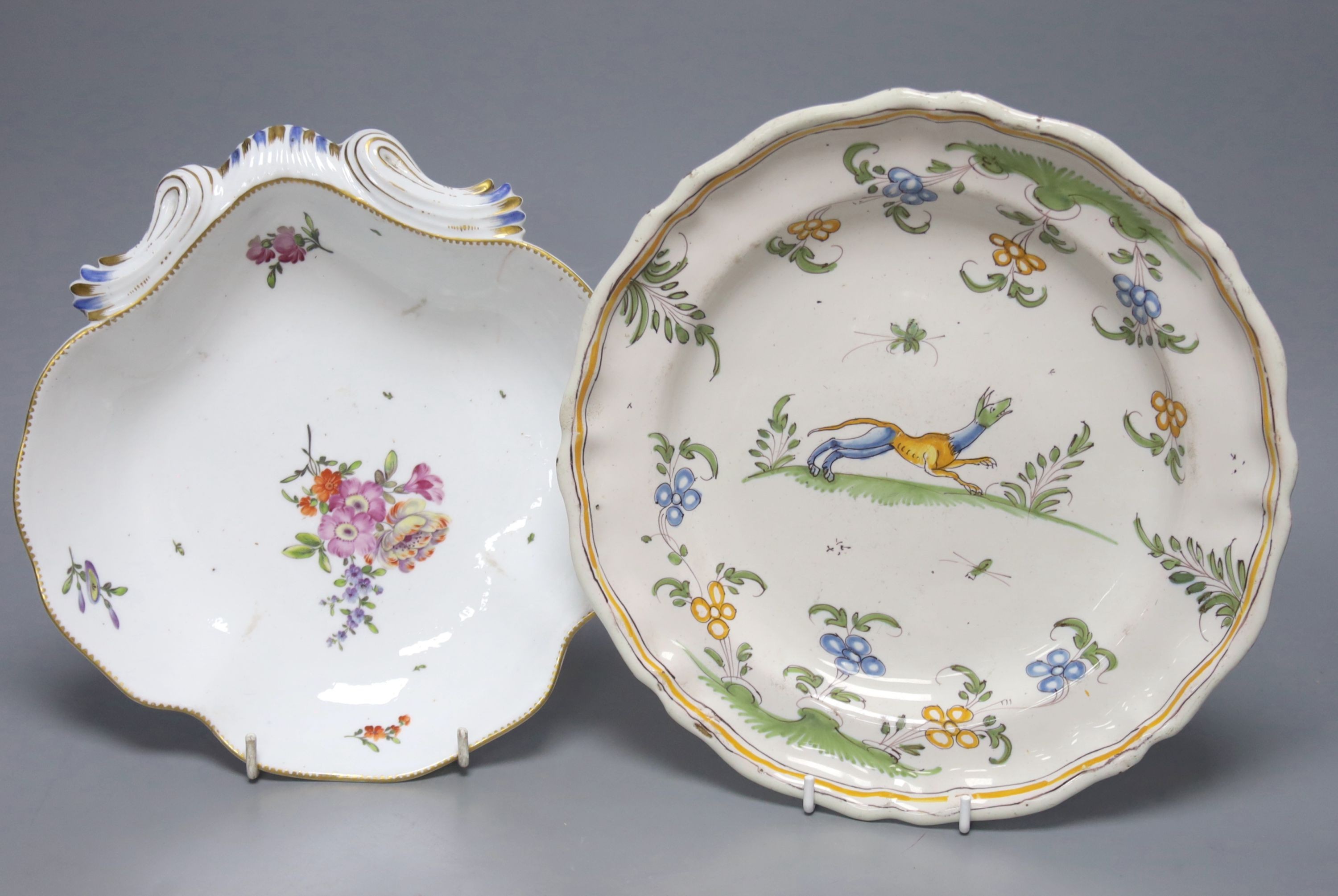 An 18th century Moustiers faience plate and a late 18th century Continental porcelain desert dish, plate 25 cms diameter.